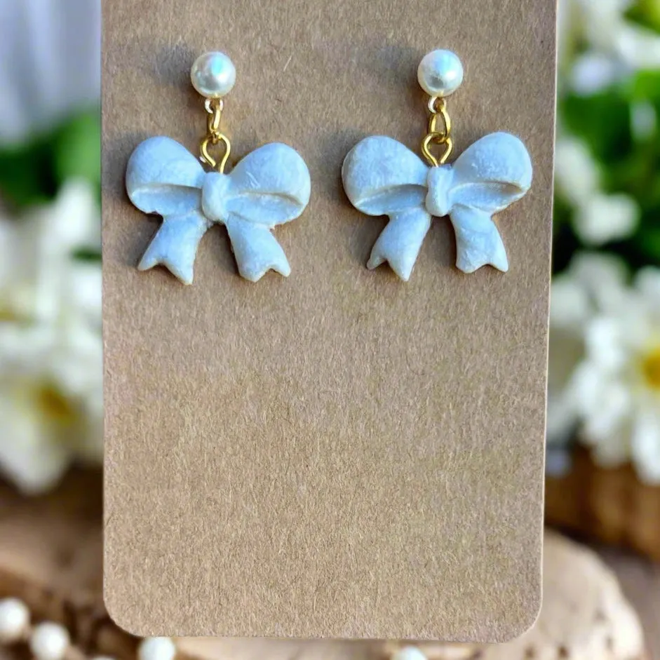 Handmade White Bow Earrings with Gold Accents and Pearl Studs – Elegant Polymer Clay Jewelry"