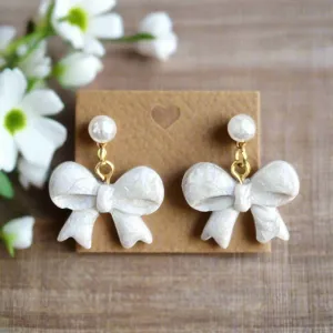 Handmade White Bow Earrings with Gold Accents and Pearl Studs – Elegant Polymer Clay Jewelry"